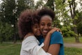 Happy African American women cuddle, friends Royalty Free Stock Photo