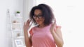 Happy african american young woman dancing at home