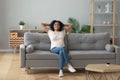 Happy black girl relaxing on cozy sofa at home Royalty Free Stock Photo