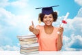 Happy african bachelor girl with books and diploma Royalty Free Stock Photo