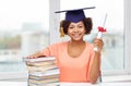 Happy african bachelor girl with books and diploma Royalty Free Stock Photo