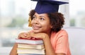 Happy african bachelor girl with books at home Royalty Free Stock Photo