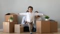 Happy african boy running in new apartment on moving day Royalty Free Stock Photo