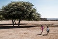 Happy african boys running to follow a kite Royalty Free Stock Photo