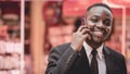 Happy african business man phone call and talking on walk for contact, chat or good deal and smile on street.Black man using Royalty Free Stock Photo