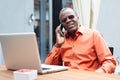 Happy african businessman using phone at cafe Royalty Free Stock Photo