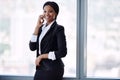 Happy african businesswoman smiling while talking on her mobile phone Royalty Free Stock Photo