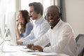 Happy african call center agent in headset posing at workplace Royalty Free Stock Photo