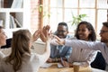 Happy african and caucasian diverse people give high five together Royalty Free Stock Photo