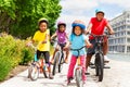 Happy African children in helmets riding bikes Royalty Free Stock Photo