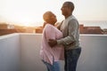 Happy african couple dancing outdoors at sunset - Soft focus on man face Royalty Free Stock Photo