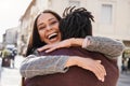 Happy african couple having fun hugging outdoor in the city - Focus on girl face Royalty Free Stock Photo