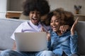 Happy African couple read e-mail on laptop celebrate auction win Royalty Free Stock Photo