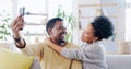 Happy African couple, selfie and sofa with hug, smile and post on web blog, love and bonding in home. Black woman, man