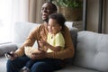 Happy african dad and kid son laughing watching funny comedy Royalty Free Stock Photo