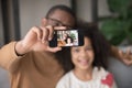 Happy african dad taking selfie with kid daughter on cellphone Royalty Free Stock Photo