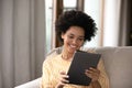 Happy african ethnicity woman using digital tablet. Royalty Free Stock Photo