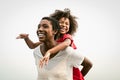 Happy African family on the beach during summer holidays - Afro people having fun on vacation time