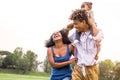 Happy African family enjoying together in public park - Mother, father and daughter having fun during a weekend sunny day outdoor Royalty Free Stock Photo