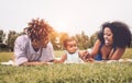 Happy African family enjoying together a weekend sunny day outdoor - Mother and father having fun with their daughter Royalty Free Stock Photo