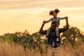 Happy African family father and child daughter travel and running on meadow nature on silhouette lights sunset. Royalty Free Stock Photo