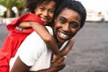 Happy African family having fun on the beach during summer holidays - Afro mother and daughter enjoying vacation days Royalty Free Stock Photo