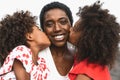 Happy African family having fun on the beach during summer holidays - Portrait of Afro people enjoying vacation days Royalty Free Stock Photo