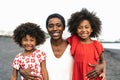 Happy African family having fun on the beach during summer holidays - Portrait of Afro people enjoying vacation days Royalty Free Stock Photo