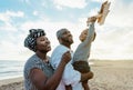 Happy African family having fun on the beach during summer vacation Royalty Free Stock Photo