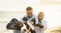 Happy African family having fun on the beach during summer vacation Royalty Free Stock Photo