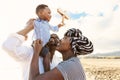 Happy African family having fun on the beach during summer vacation Royalty Free Stock Photo