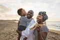 Happy African family having fun on the beach during summer vacation Royalty Free Stock Photo