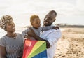 Happy African family having fun on the beach during summer vacation Royalty Free Stock Photo