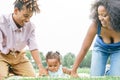 Happy African family having fun doing picnic in public park - Mother and father playing with their daughter outdoor Royalty Free Stock Photo