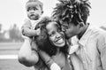 Happy African family having fun in a park outdoor - Mother and father with their daughter enjoying time together in a weekend day Royalty Free Stock Photo