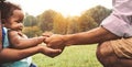 Happy African family having fun together in public park - Black father and mother holding hand with their daughter Royalty Free Stock Photo