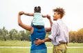 Happy African family having fun together in public park - Mother, father and daughter enjoying a sunny weekend day outdoor Royalty Free Stock Photo