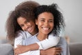 Happy african family mother and teen girl embracing mom, portrait Royalty Free Stock Photo