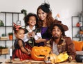 Happy african family parents with kids preparing Halloween decorations at home Royalty Free Stock Photo