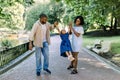 Happy African family in the park in the summer sunny evening. Mom, dad and happy daughter walk at sunset, parents Royalty Free Stock Photo