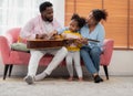 Happy african family playing guitar and singing together at home Royalty Free Stock Photo