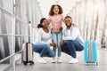 Happy african family traveling, posing together in airport Royalty Free Stock Photo