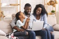 Happy african family watching movie on laptop at home together Royalty Free Stock Photo