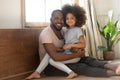 Happy african dad and kid daughter bonding looking at camera Royalty Free Stock Photo