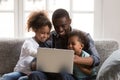 Happy african father and children using laptop doing family shop Royalty Free Stock Photo