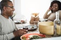 Happy african father drinking yerba mate during lunch at home - Main focus on man face