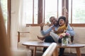 Happy African Father and little child son spending time playing wooden airplane toy at home together Royalty Free Stock Photo