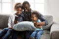 Happy african father taking selfie with cute kids on smartphone Royalty Free Stock Photo