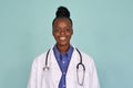 Happy african female doctor looking at camera on mint background, portrait. Royalty Free Stock Photo