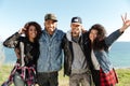 Happy african friends walking outdoors on the beach Royalty Free Stock Photo